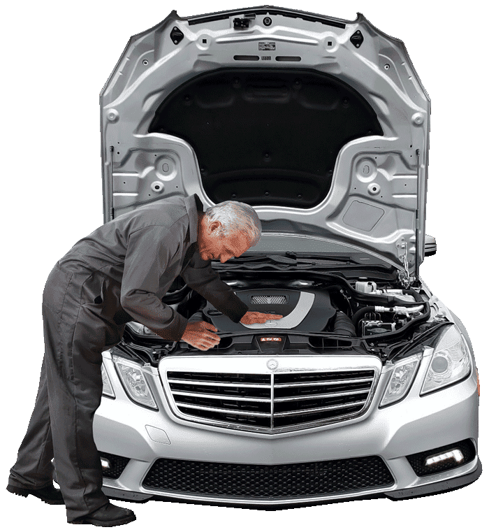 a mechanic inspecting the engine of a silver Mercedes