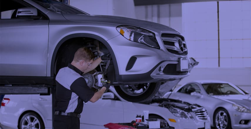 mechanic replacing a Mercedes air strut
