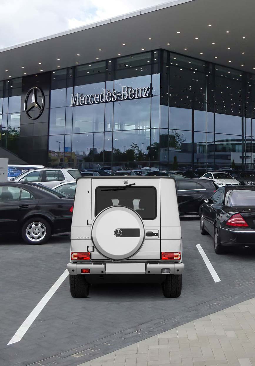 Mercedes cars parked in front of a large building
